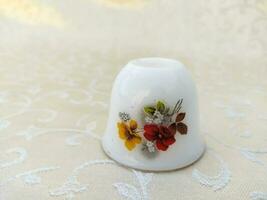 vintage cups with floral textures are uniquely arranged on the table photo