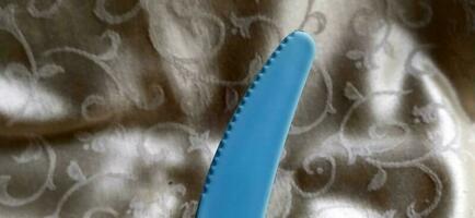 The knife for cutting steak is blue, made of plastic photo