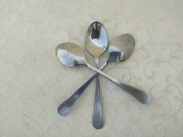 several aluminum spoons arranged uniquely on the table photo