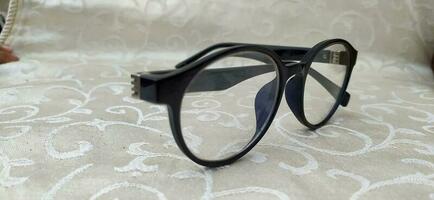 Round reading glasses in dark blue photo