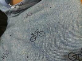 Photo of a gray cloth texture with a bicycle image