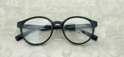 Round reading glasses in dark blue photo