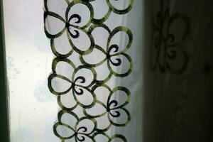 A curtain in front of the window with a transparent color and a flower pattern photo