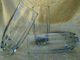 Clear white drinking glass made of glass with an elongated shape photo