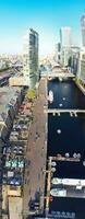 High Angle Panoramic View of Canary Wharf Buildings at Central London City of England Great Britain. The Footage Was Captured with Drone's Camera at Low Altitude on 08-June-2023 During Sunset. photo