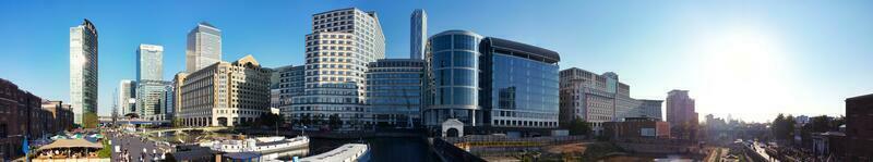 High Angle Panoramic View of Canary Wharf Buildings at Central London City of England Great Britain. The Footage Was Captured with Drone's Camera at Low Altitude on 08-June-2023 During Sunset. photo