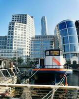 Low Angle Panoramic View of Canary Wharf Central London City with Tall Buildings, Road, People at Most Expensive Area of London City of England UK. The Footage Was Captured on 08-June-2023 photo