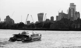 Low Angle Panoramic View of Canary Wharf Central London City with Tall Buildings, Road, People at Most Expensive Area of London City of England UK. The Footage Was Captured on 08-June-2023 photo