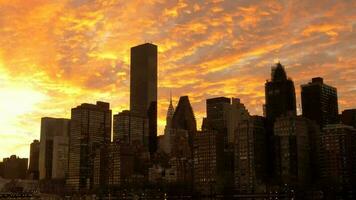 Motion time lapse of clouds moving over city skyline at sunset sky video