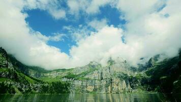 Time lapse of clouds moving over lake mountain landscape video