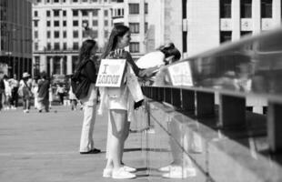 Gorgeous View of People are Enjoying Warm Day of 4-June-2023 at the Edge of River Thames of Central London England UK. Most of the Families and young couples are Walking Around and Enjoying their Time photo