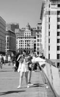 Gorgeous View of People are Enjoying Warm Day of 4-June-2023 at the Edge of River Thames of Central London England UK. Most of the Families and young couples are Walking Around and Enjoying their Time photo