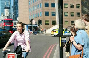 Beautiful Low Angle View of Central London and Road with Traffic and People. The Image Was Captured at Tower Bridge London England Great Britain on Warm Sunny Day of 04-June-2023 photo