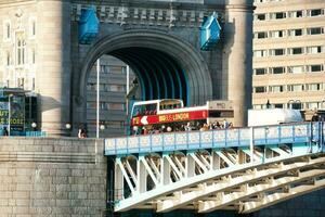 Beautiful Low Angle View of Central London and Road with Traffic and People. The Image Was Captured at Tower Bridge London England Great Britain on Warm Sunny Day of 04-June-2023 photo