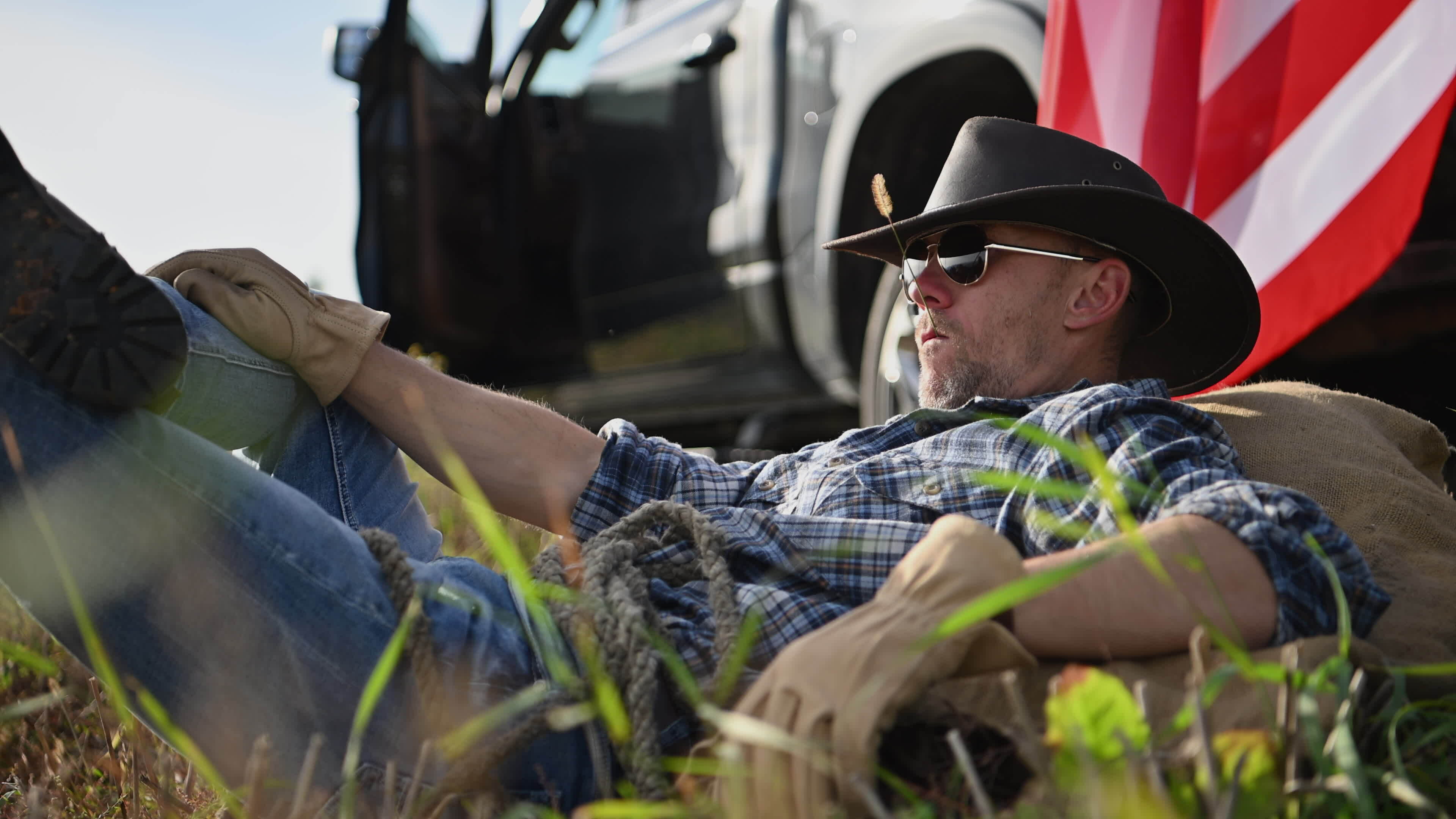 Patriotic American Farmer in Cowboy Hat and Aviator Style Sunglasses