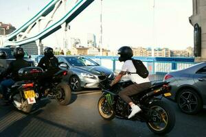 Beautiful Low Angle View of Central London and Road with Traffic and People. The Image Was Captured at Tower Bridge London England Great Britain on Warm Sunny Day of 04-June-2023 photo