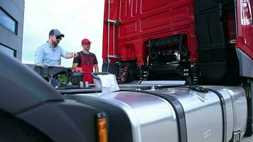 caucasico camion meccanico e autista discutere alcuni problemi con il veicolo video