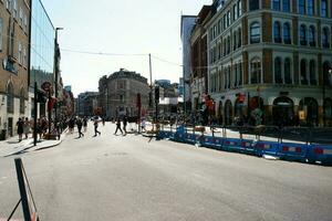 Beautiful Low Angle View of Central London and Road with Traffic and People. The Image Was Captured at Tower Bridge London England Great Britain on Warm Sunny Day of 04-June-2023 photo