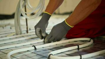 HVAC Worker Installing Residential Radiant Floor Heating Plastic Pipeline. video