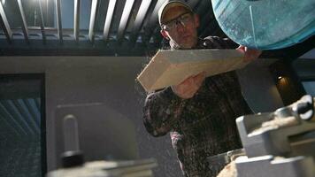 Crpenter Blowing Off Sawdust From the Beam. Woodwork Theme. video