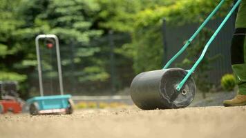 Compacting Soil Using Lawn Roller video