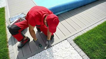 Composite Backyard Poolside Deck Building by Professional Landscaper and Pool Technician Worker. video