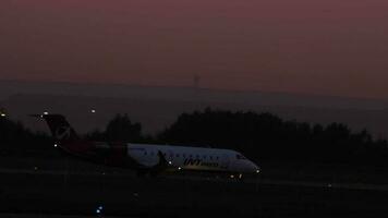 KAZAN, RUSSIA AUGUST 05, 2022 - Aircraft CRJ 200 Bombardier of UVT Aero taxiing at dusk, at night, at dawn. Russian regional airline video