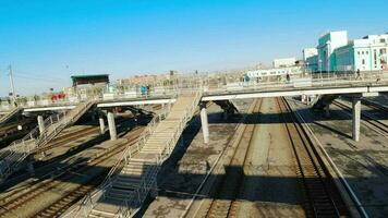 Overpass for pedestrians at the railway station. Railway bridge in the city. Reinforced concrete structure video