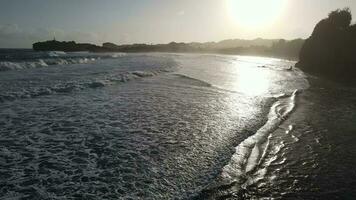 Aerial view of beautiful sunset at Beach in Indonesia with yellow sunny day. video