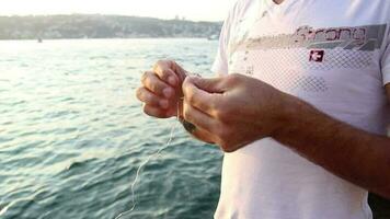 Fisherman preparing fishing rod video