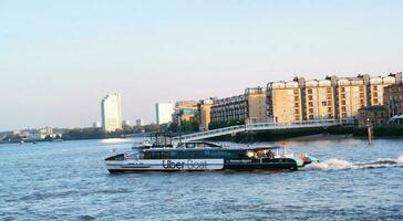 Low Angle view of Central London Buildings and River Thames at Canary Wharf Central London. The Footage Was Captured During Sunset over London City of England UK on June 08, 2023 photo