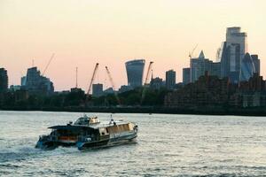 Low Angle view of Central London Buildings and River Thames at Canary Wharf Central London. The Footage Was Captured During Sunset over London City of England UK on June 08, 2023 photo