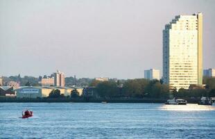 Low Angle view of Central London Buildings and River Thames at Canary Wharf Central London. The Footage Was Captured During Sunset over London City of England UK on June 08, 2023 photo