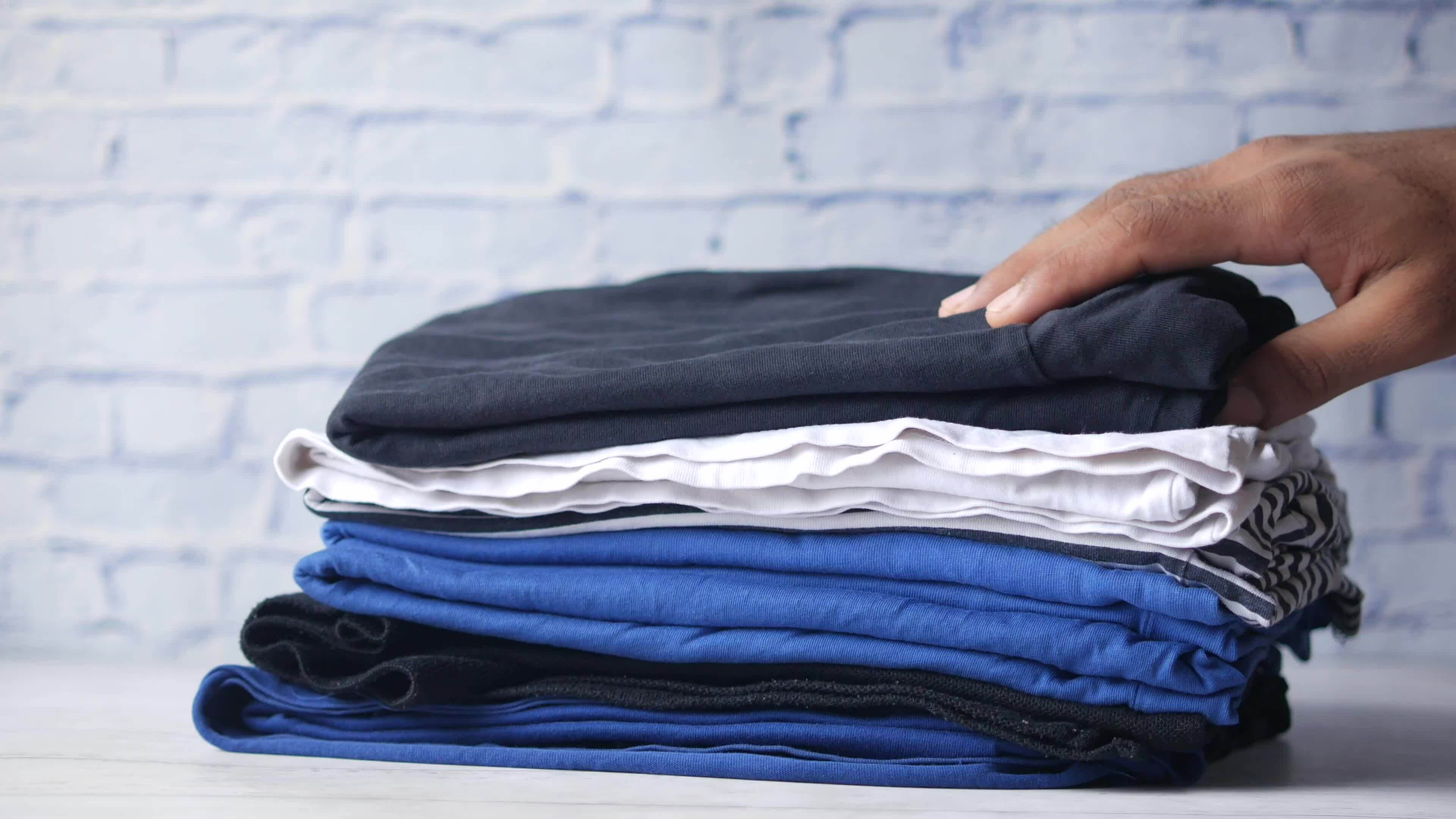 putting cloths on a table against wall background 24833708 Stock Video