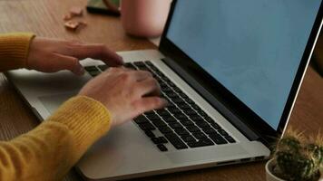 Close up of the hands of a woman typing in front of her computer screen. video