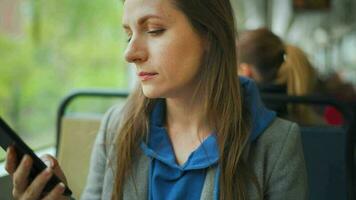 Public transport. Woman in tram using smartphone video