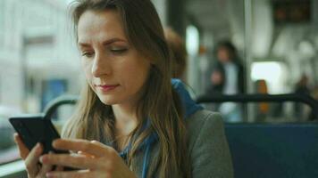 Public transport. Woman in tram using smartphone video