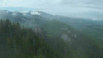 Flying through the clouds, close to the rocks. High Tatras, Slovakia video