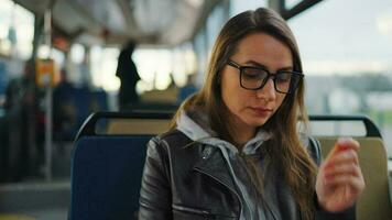 Public transport. Woman in tram using smartphone video