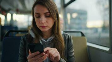 Public transport. Woman in tram using smartphone video