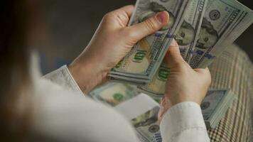 Woman counting US Dollar bills or paying in cash video