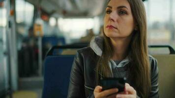 Public transport. Woman in tram using smartphone video