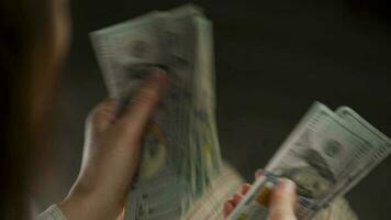 Woman counting US Dollar bills or paying in cash video