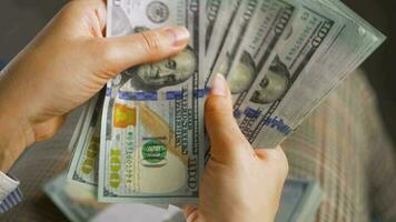 Woman counting US Dollar bills or paying in cash video