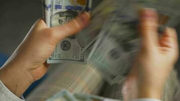 Woman counting US Dollar bills or paying in cash video