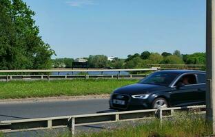 Most Beautiful Low Angle View of British City and Road of Milton Keynes City of England UK. The Footage Was Captured on 21-May-2023 During Warm Sunny Day of Summer. photo