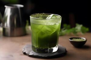 Matcha Green Tea with an ice cube in a glass. Close up. . photo