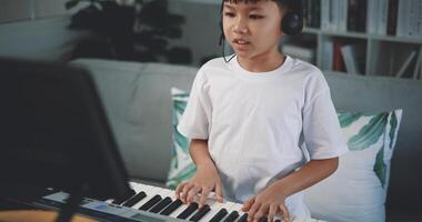 Cute boy enjoy to learning playing piano at home photo