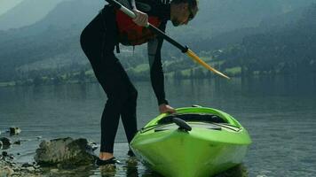 Kayaker Taking Off. Kayaking on the Scenic Mountain Lake. video