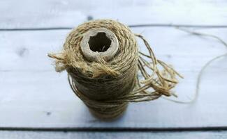 Roll of twine on a white wooden background. photo